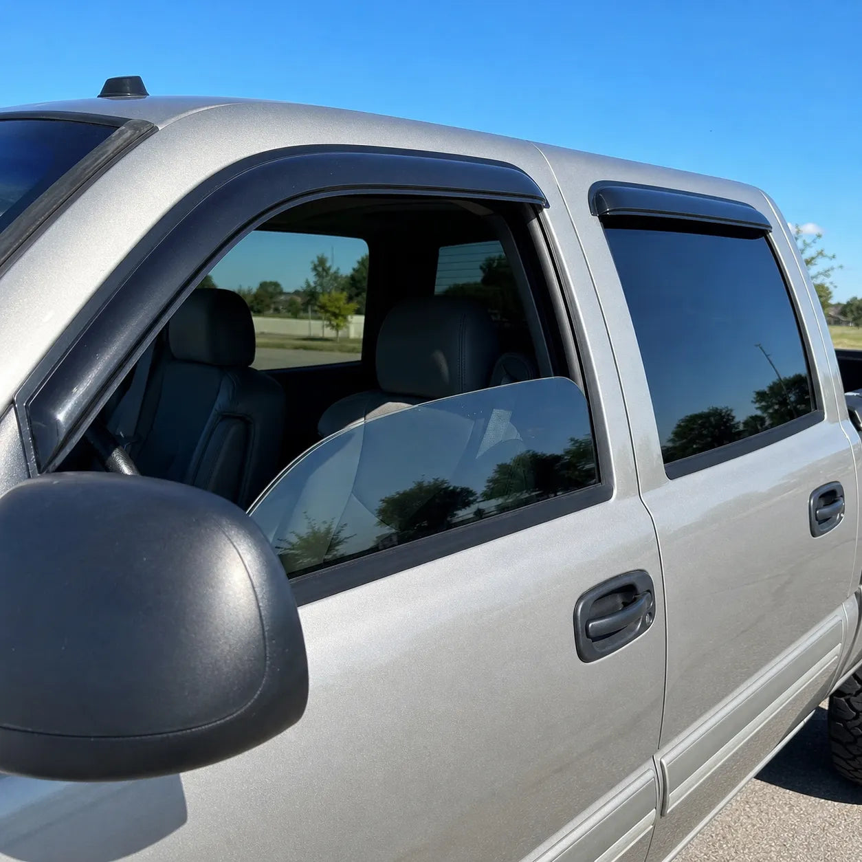 Chevy Silverado Crew Cab with smoke window visor rain guards installed on front and rear windows
