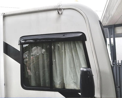 Universal dark smoke visor wind deflector installed above an RV side window for rain protection and ventilation